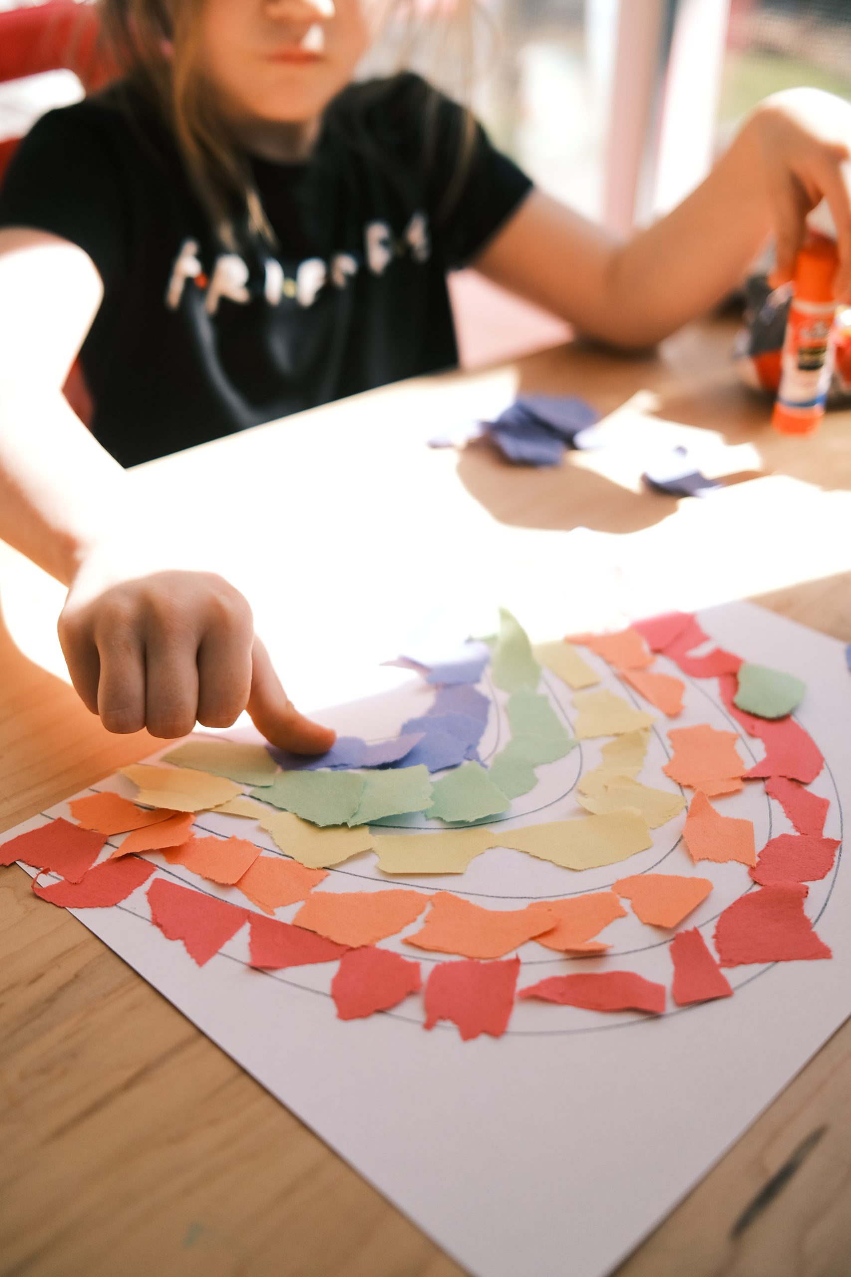 preschool-fun-math-activities.  A student making a rainbow out of torn paper.