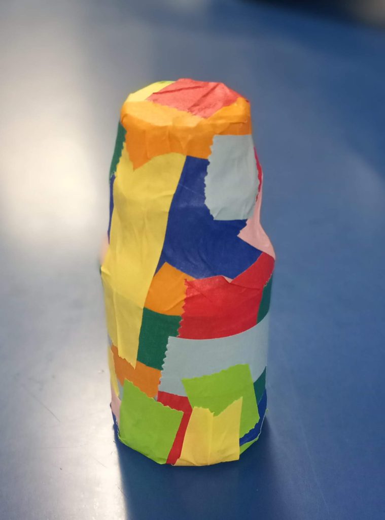 Multi Colored Masking tape wrapped on a small milk container made into a shaker