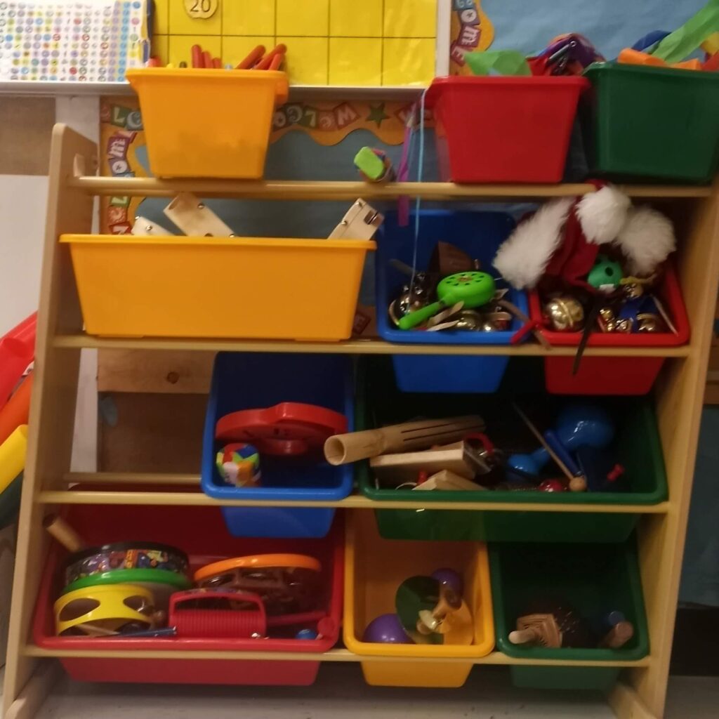 A shelf full of rhythm instruments for children